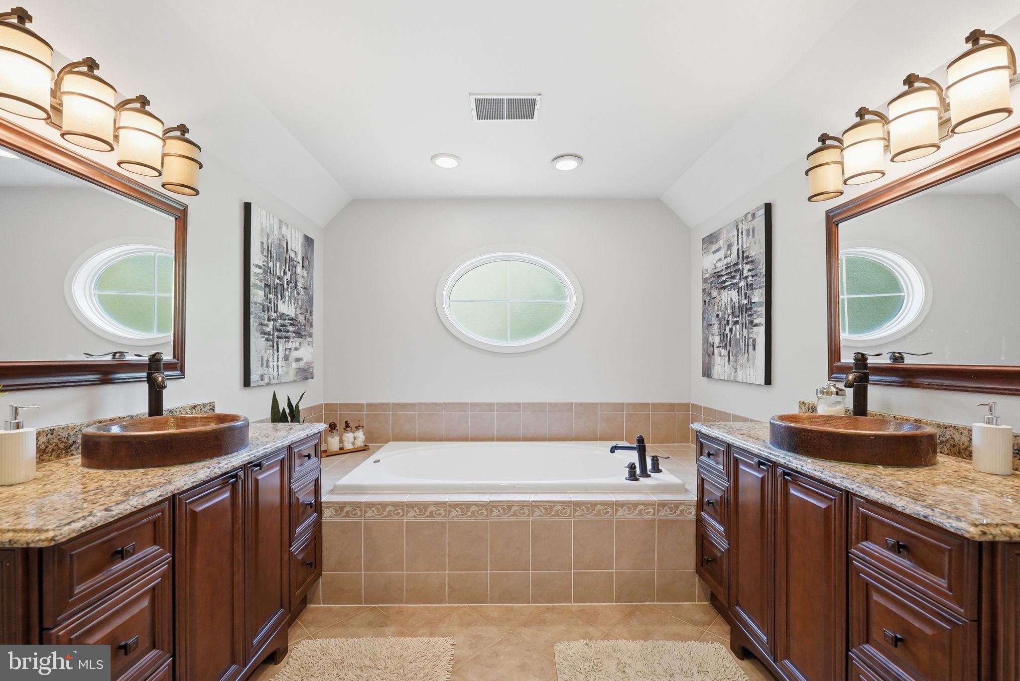 6075 Deer Ridge Trail Springfield, VA 22150 - Photo 24 of 61 a bathroom with a granite countertop bathtub a sink and a mirror