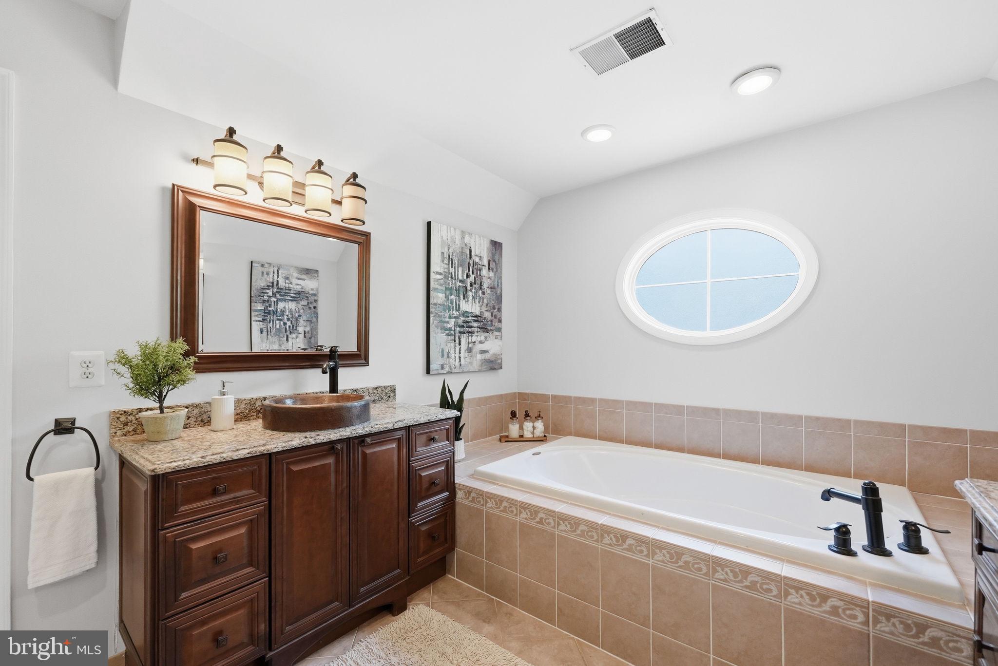 6075 Deer Ridge Trail Springfield, VA 22150 - Photo 25 of 61 a bathroom with a tub sink and mirror