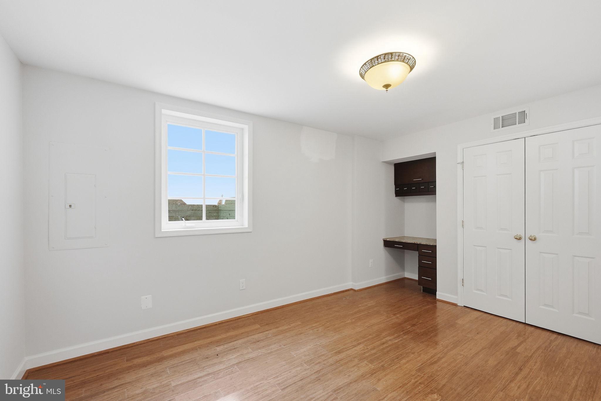 6075 Deer Ridge Trail Springfield, VA 22150 - Photo 26 of 61 a view of an empty room with wooden floor and a window