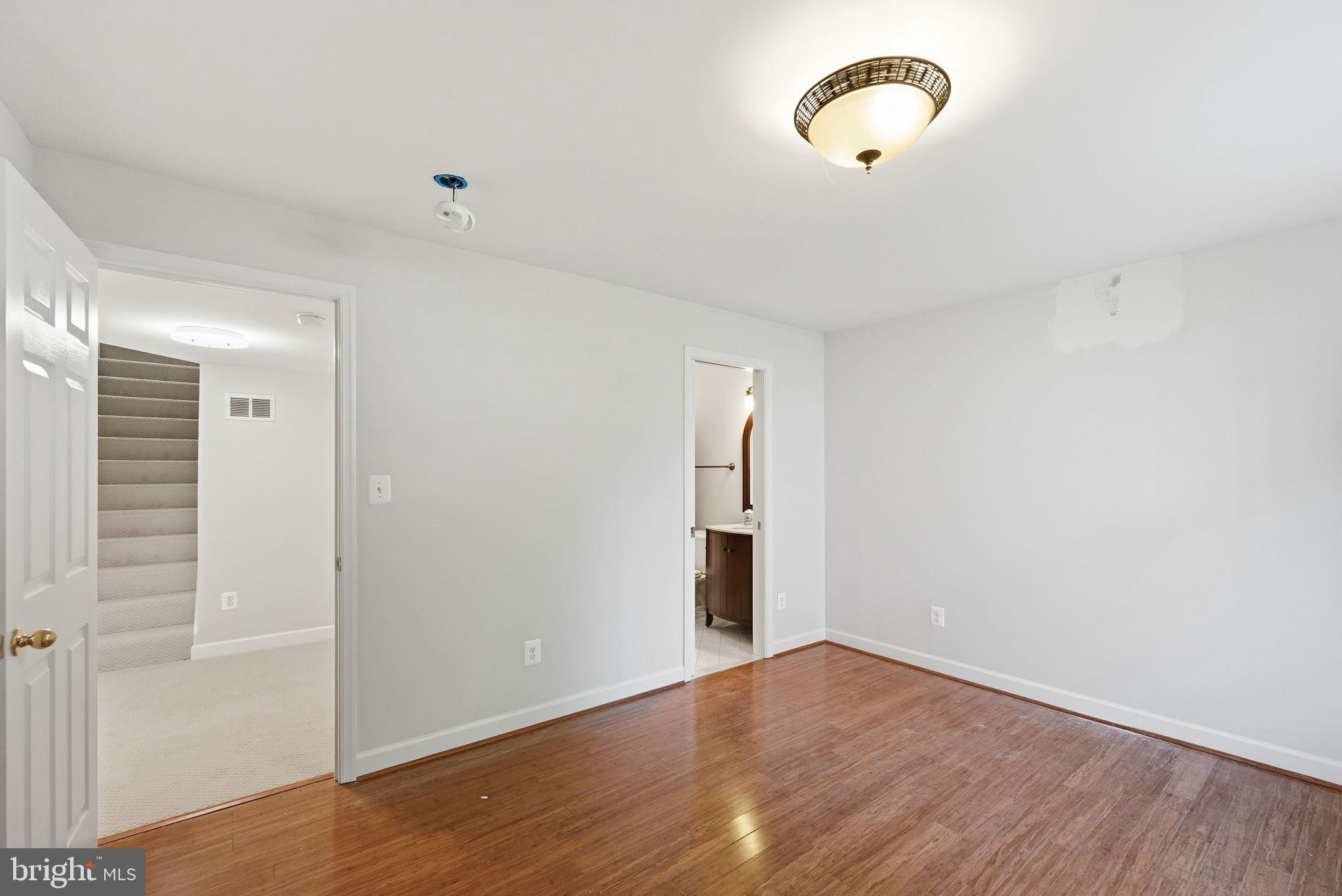 6075 Deer Ridge Trail Springfield, VA 22150 - Photo 27 of 61 a view of an empty room with wooden floor