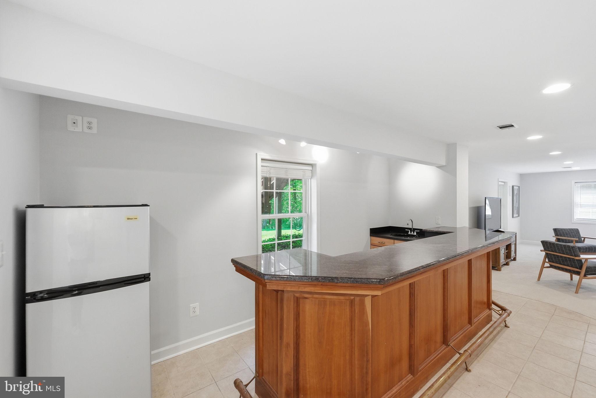6075 Deer Ridge Trail Springfield, VA 22150 - Photo 34 of 61 a kitchen with stainless steel appliances granite countertop a refrigerator a sink a stove and a refrigerator