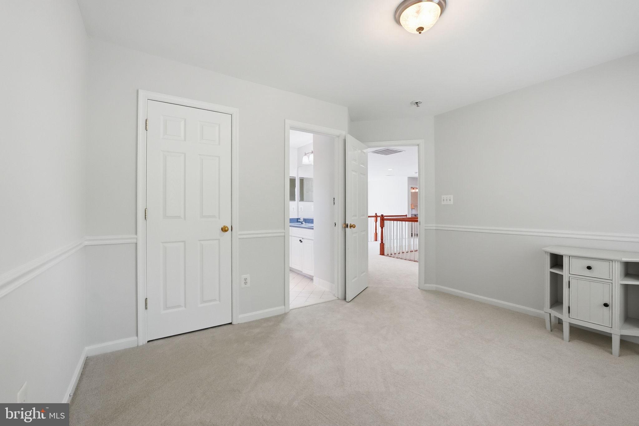 6075 Deer Ridge Trail Springfield, VA 22150 - Photo 42 of 61 an empty room with a cabinet and mirrors