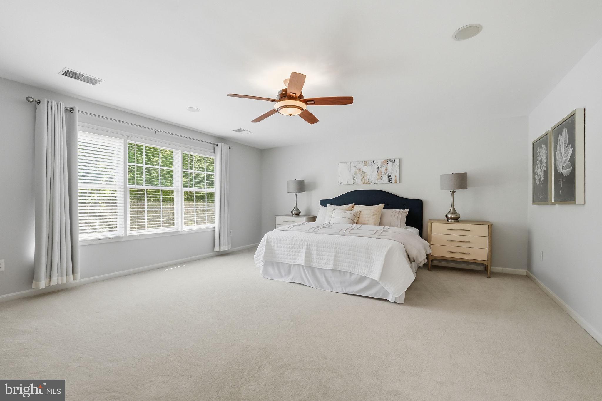 6075 Deer Ridge Trail Springfield, VA 22150 - Photo 55 of 61 a spacious bedroom with a bed and a chandelier