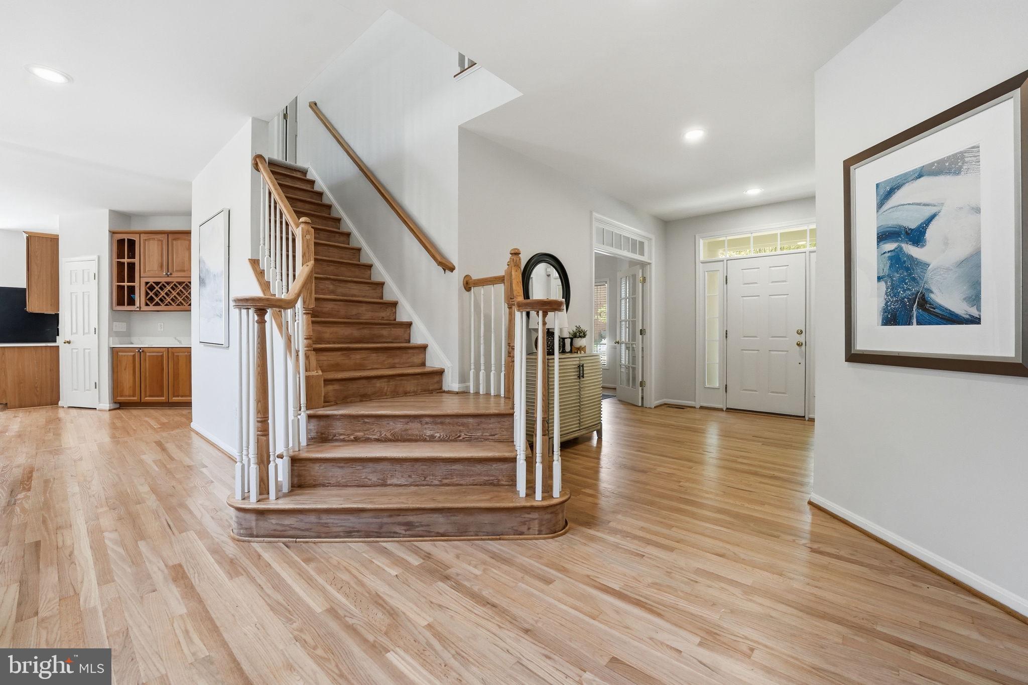 6075 Deer Ridge Trail Springfield, VA 22150 - Photo 9 of 61 a view of a hallway with wooden floor and staircase