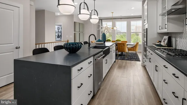 a kitchen with counter top space a sink stainless steel appliances and cabinets