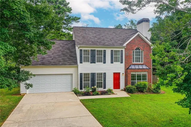 a front view of a house with a yard