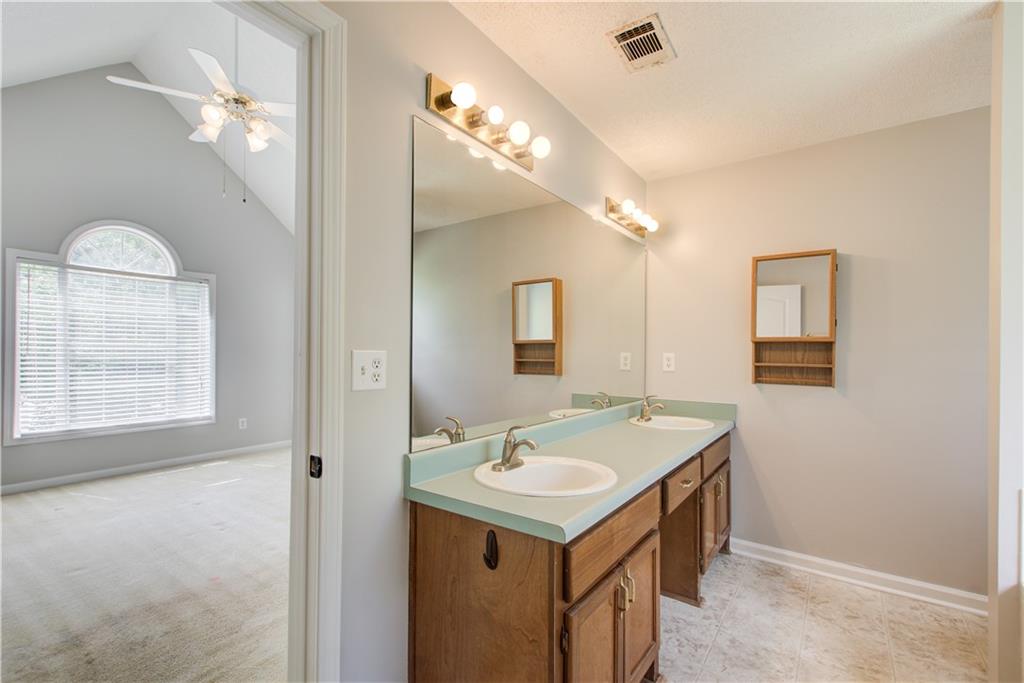 837 Ravins Way Stockbridge, GA 30281 - Photo 17 of 32 a bathroom with a sink a mirror and a vanity