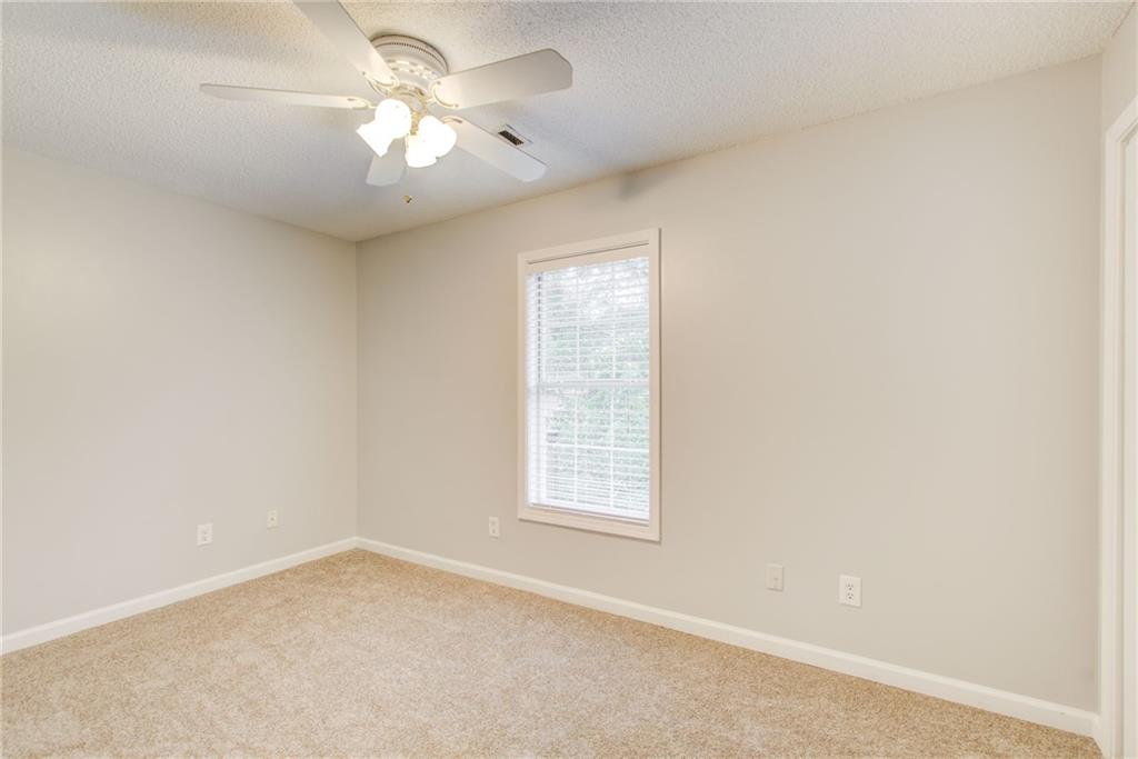 837 Ravins Way Stockbridge, GA 30281 - Photo 20 of 32 an empty room with a window and a ceiling fan
