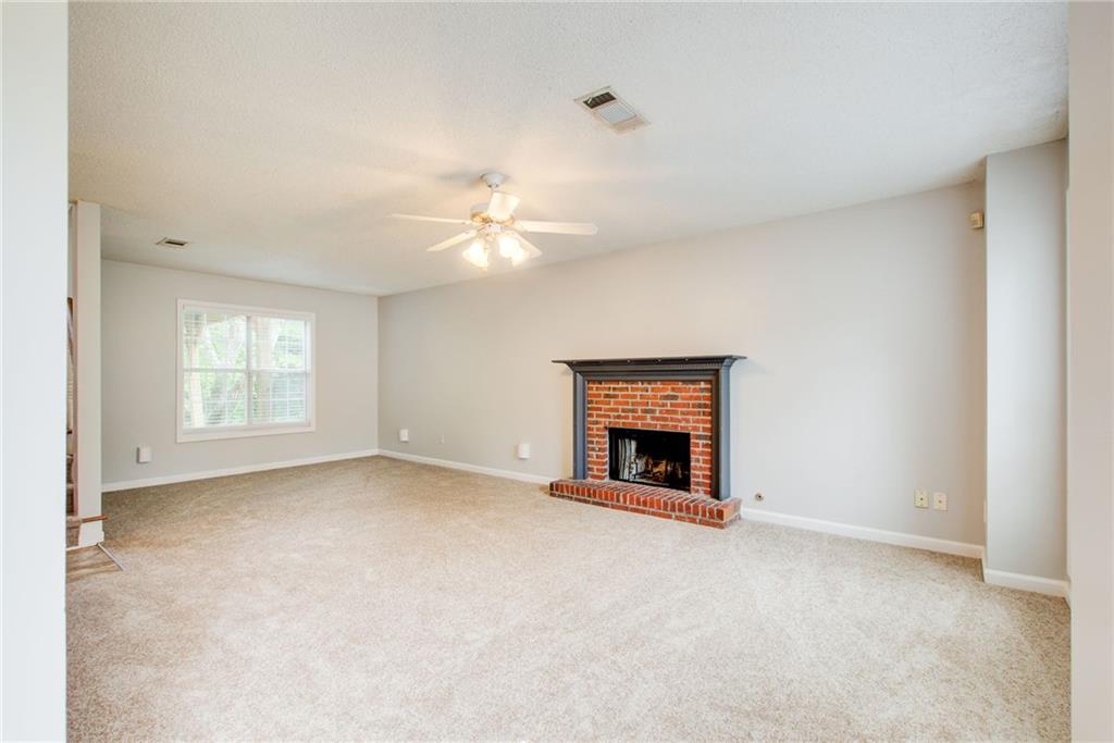 837 Ravins Way Stockbridge, GA 30281 - Photo 2 of 32 an empty room with windows and fireplace