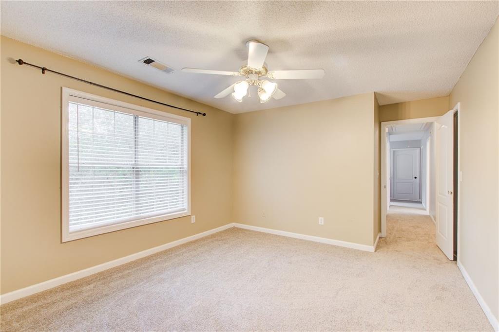 837 Ravins Way Stockbridge, GA 30281 - Photo 23 of 32 a view of an empty room with chandelier fan and a window