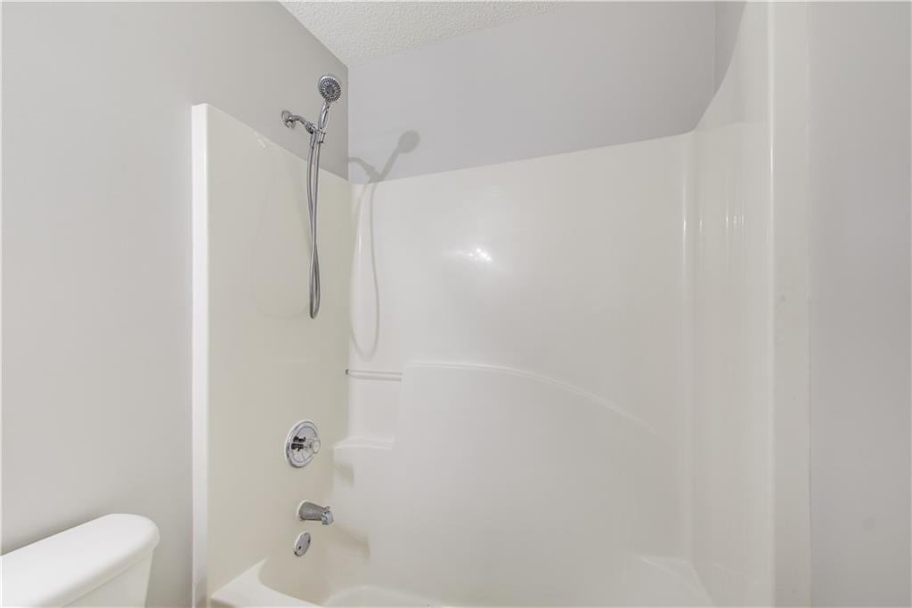 837 Ravins Way Stockbridge, GA 30281 - Photo 24 of 32 a bathroom with a bathtub and shower