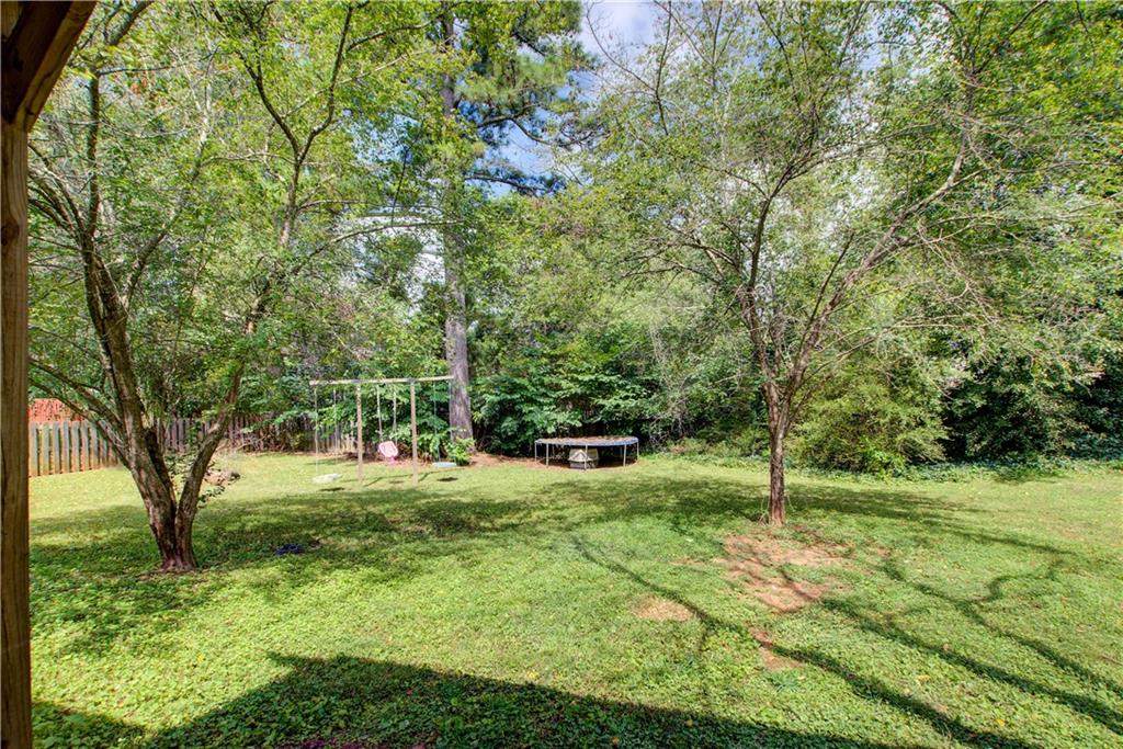 837 Ravins Way Stockbridge, GA 30281 - Photo 26 of 32 a view of a yard with a tree