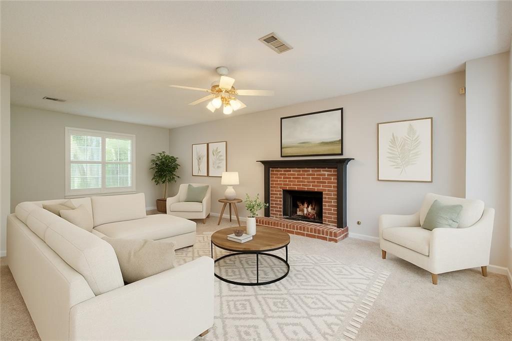 837 Ravins Way Stockbridge, GA 30281 - Photo 3 of 32 a living room with furniture a fireplace and a large window