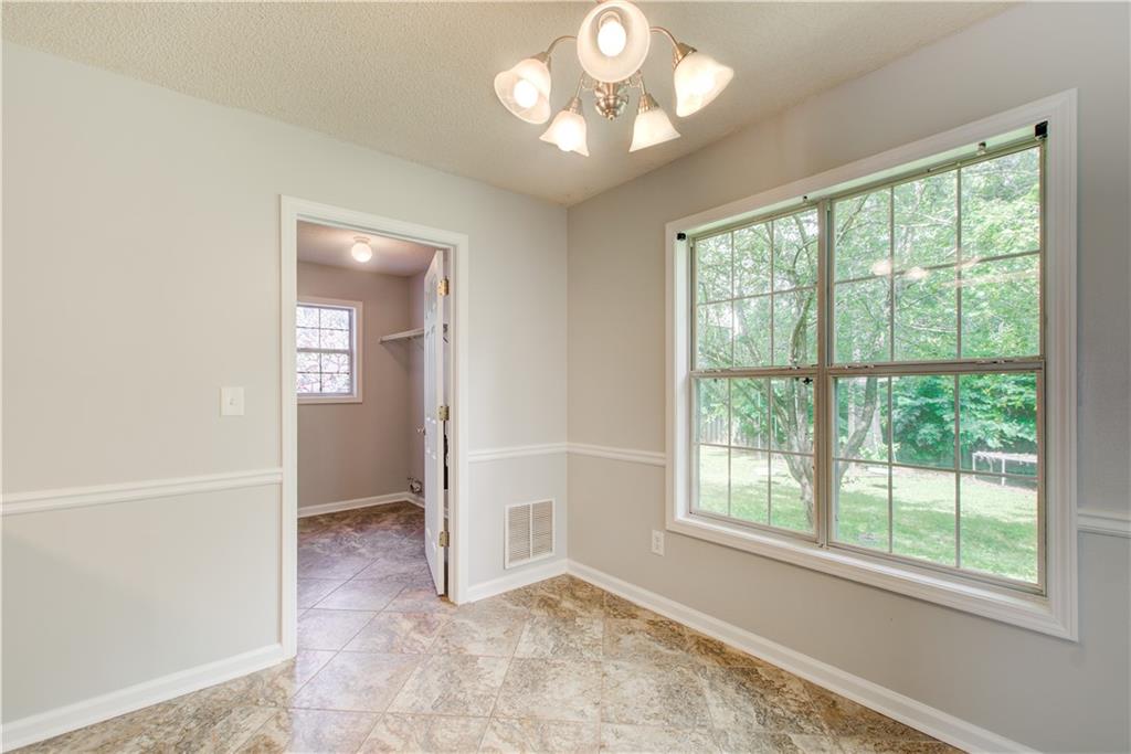 837 Ravins Way Stockbridge, GA 30281 - Photo 8 of 32 an empty room with fan and windows