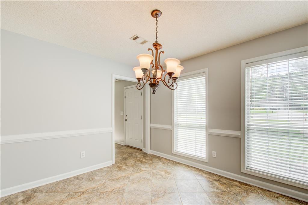 837 Ravins Way Stockbridge, GA 30281 - Photo 9 of 32 a view of a chandelier in a room