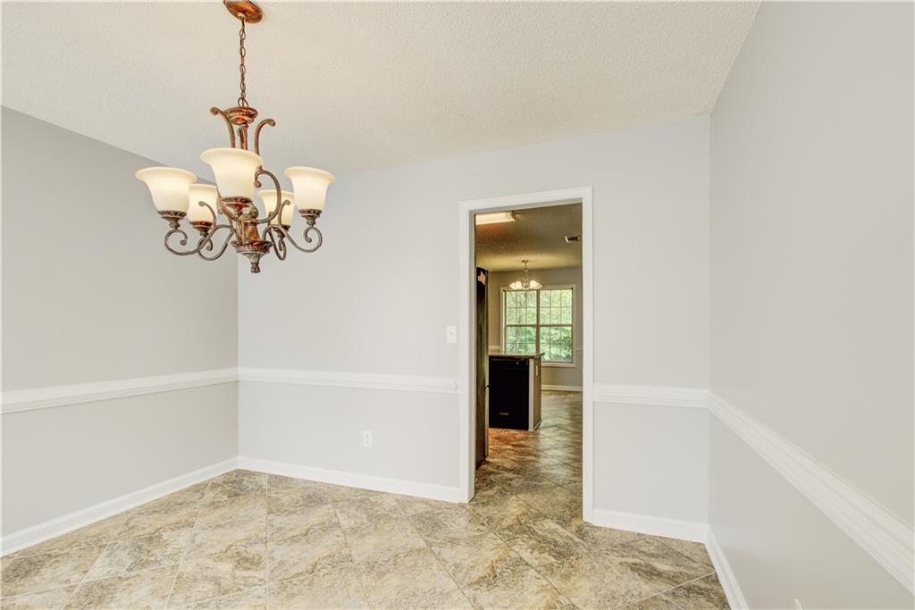 837 Ravins Way Stockbridge, GA 30281 - Photo 10 of 32 a view of a hallway with a chandelier