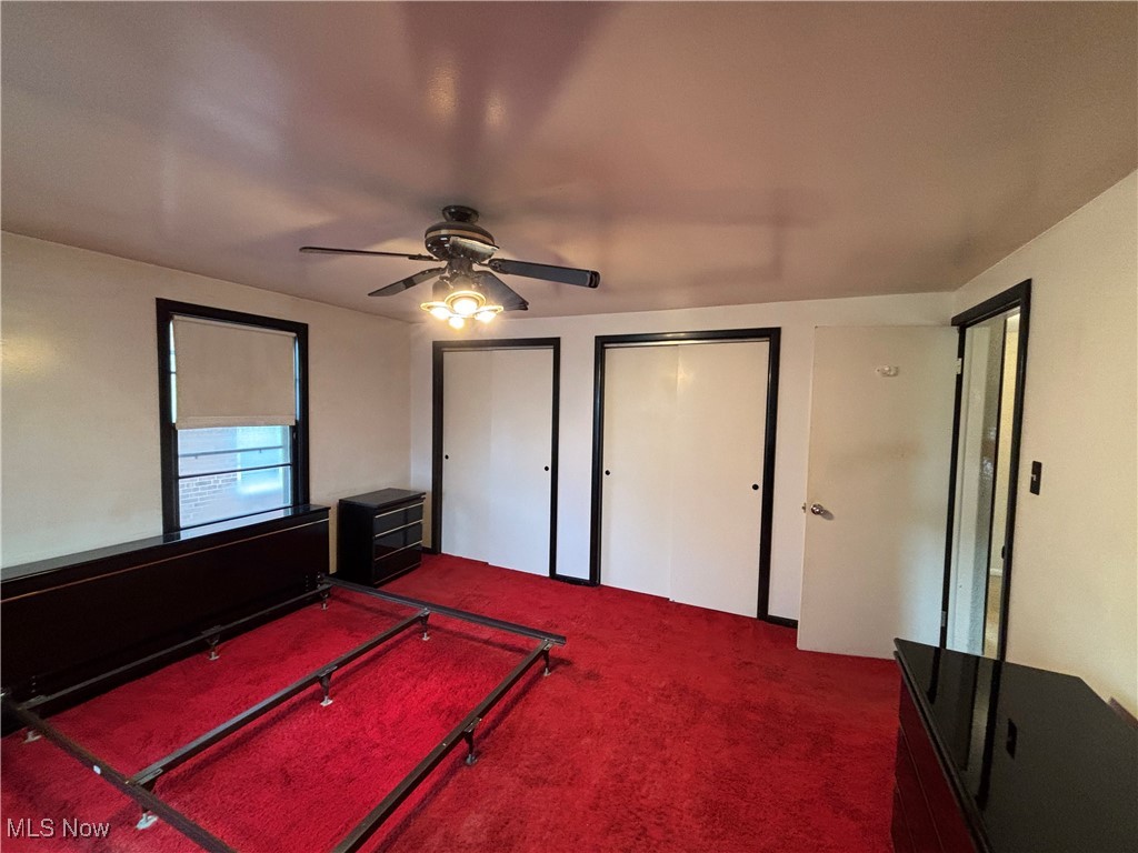 4308 Silsby Road University Heights, OH 44118 - Photo 11 of 28 Unfurnished bedroom featuring carpet flooring, ceiling fan, and two closets