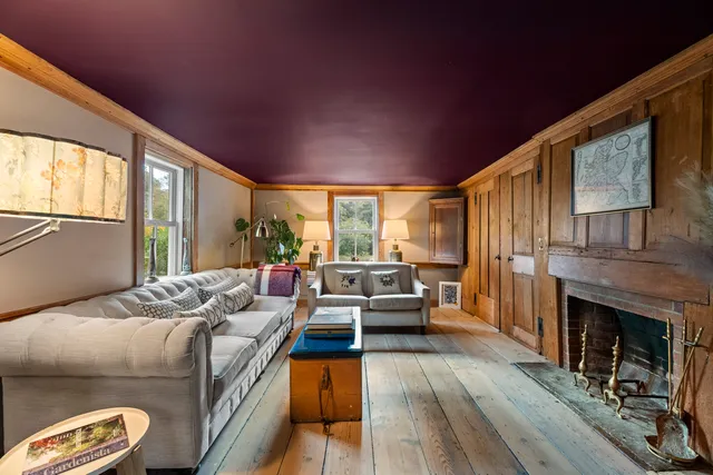 a living room with furniture fireplace and window