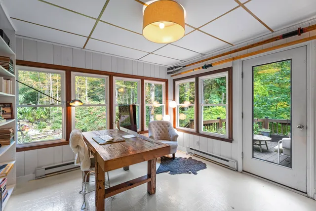 a living room with furniture and a floor to ceiling window