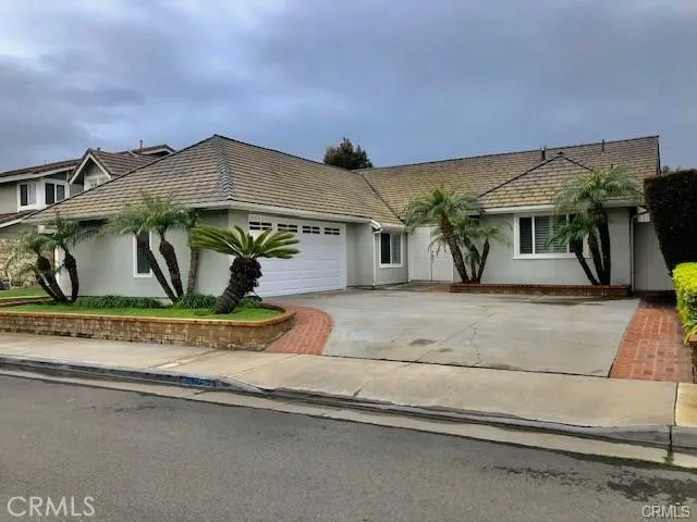 a view of a house with a yard and sitting area