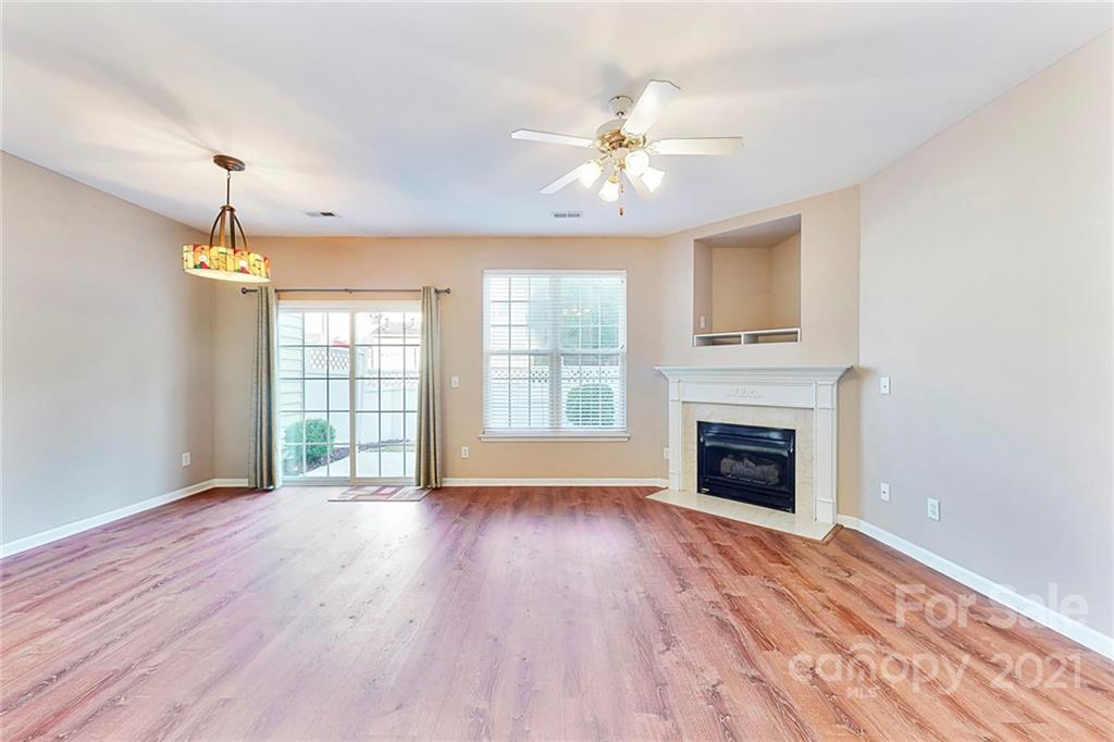 924 Azurine Circle Fort Mill, SC 29708 - Photo 9 of 41 a view of an empty room with wooden floor fireplace and a window