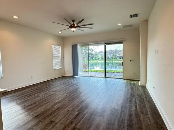 a view of a livingroom with wooden floor and a window