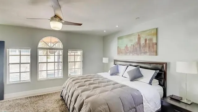 a bedroom with a large bed and a window