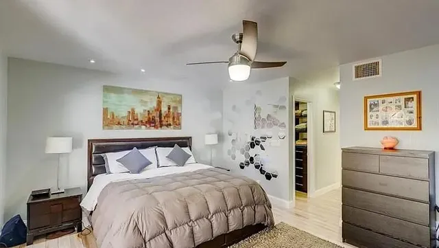 a bedroom with a bed and a chandelier