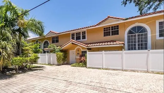 a view of a house with a wooden fence