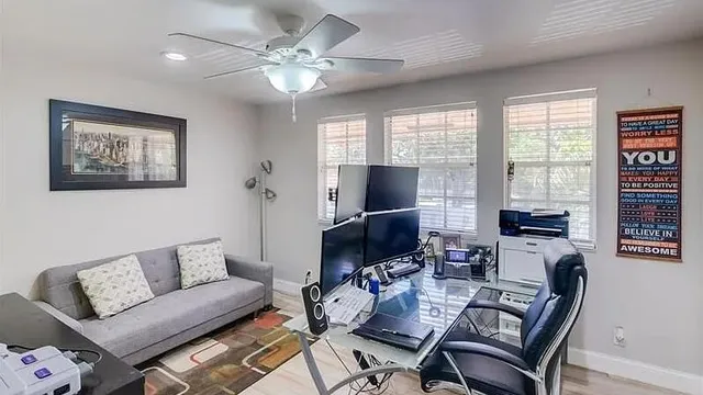 a living room with furniture a large window and a flat screen tv