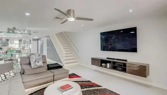 a living room with furniture and a flat screen tv