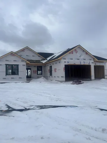 a front view of a house with a garage and a fireplace