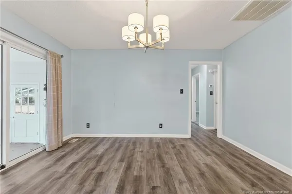 a view of a room with wooden floor and window