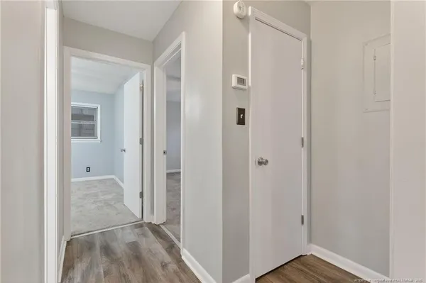 a view of a room with wooden floor
