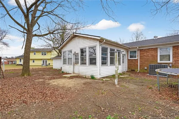 a view of house with backyard and tree