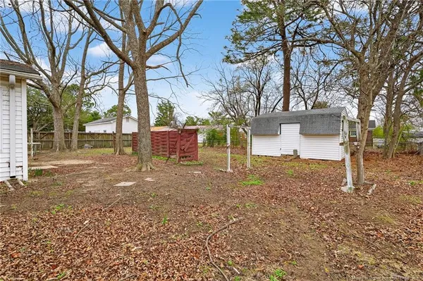 a view of a yard with a house and a tree