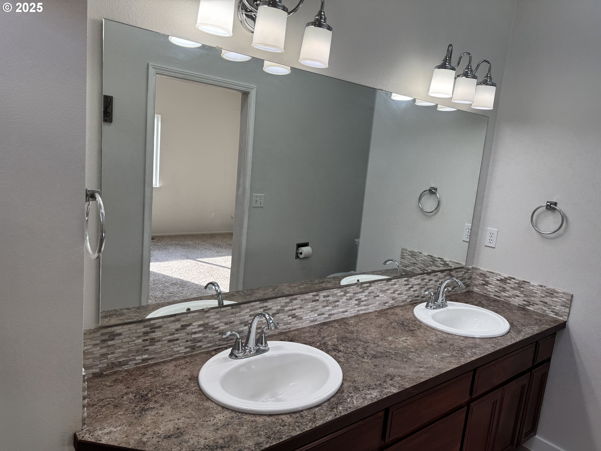 4015 Scenic Drive, Unit 4027 Eugene, OR 97404 - Photo 13 of 26 a bathroom with a granite counter sink and a mirror