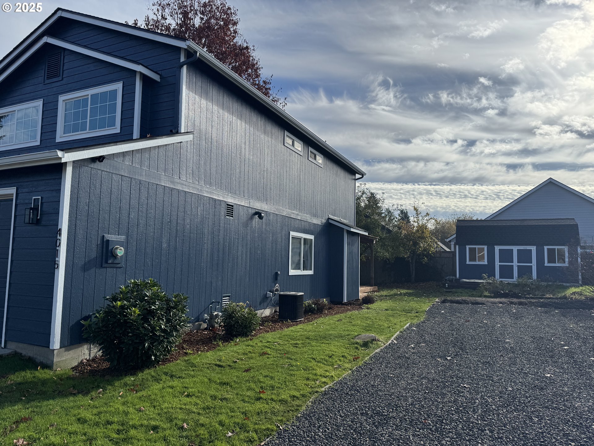 4015 Scenic Drive, Unit 4027 Eugene, OR 97404 - Photo 2 of 26 a view of a house with brick walls and a yard with plants