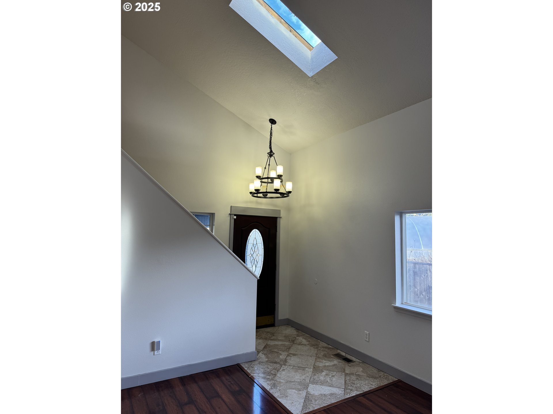 4015 Scenic Drive, Unit 4027 Eugene, OR 97404 - Photo 3 of 26 a room with wooden floor and chandelier