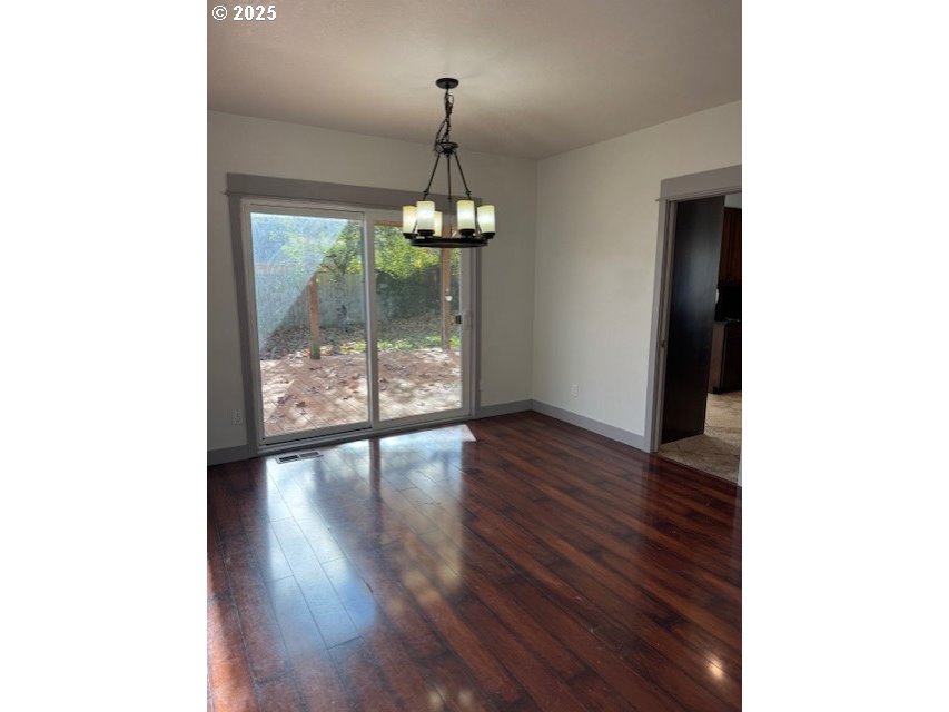 4015 Scenic Drive, Unit 4027 Eugene, OR 97404 - Photo 6 of 26 a view of a hallway with wooden floor and chandelier