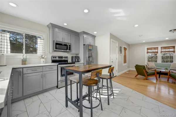 a kitchen with stainless steel appliances kitchen island granite countertop a sink and cabinets