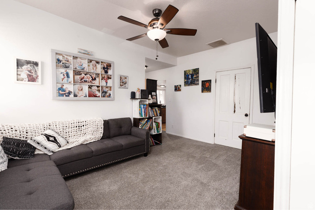 197 West 100 South Redmond, UT 84652 - Photo 8 of 41 Living area with carpet floors and a ceiling fan
