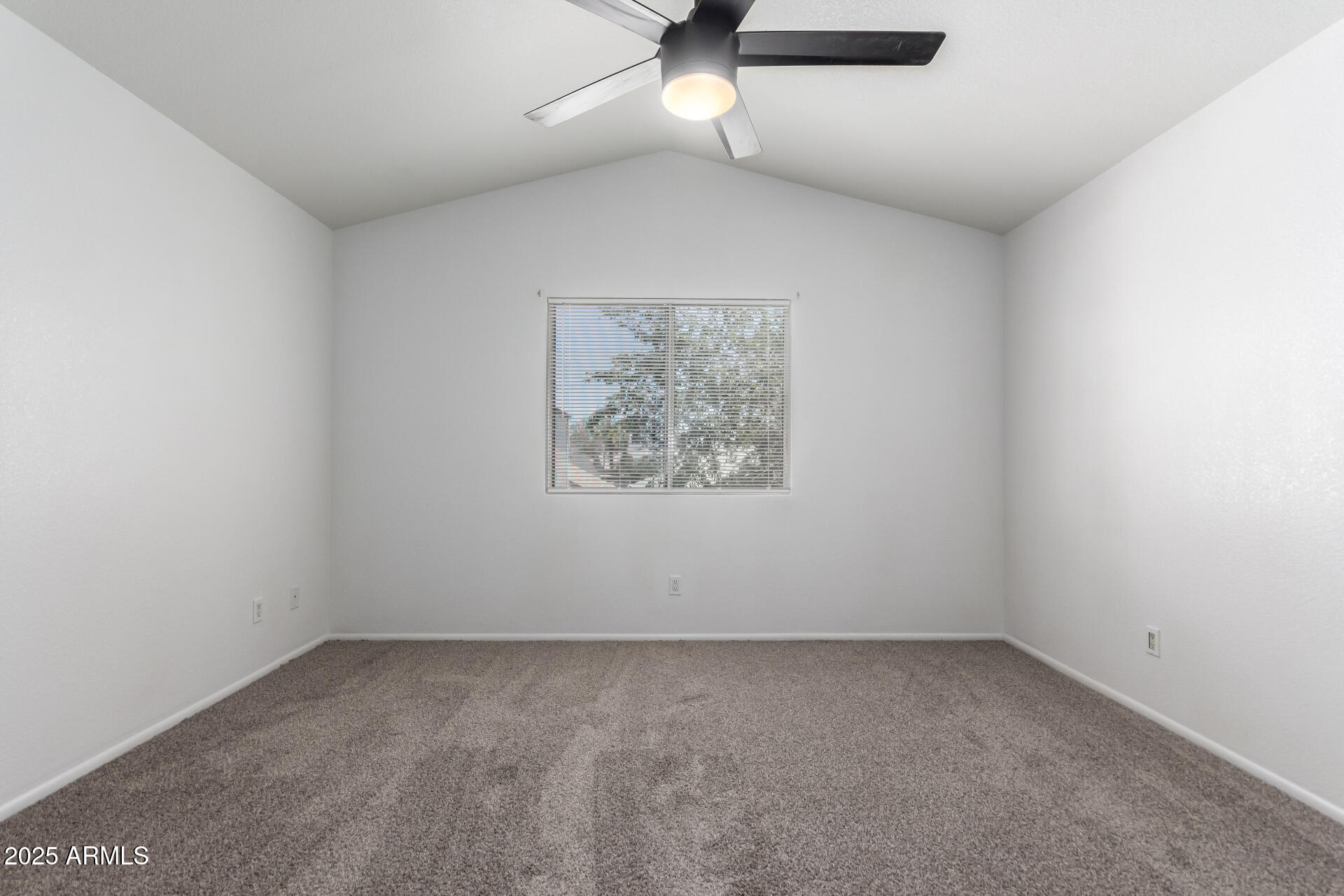 4162 East Wayland Road Phoenix, AZ 85040 - Photo 10 of 36 an empty room with a ceiling fan and window
