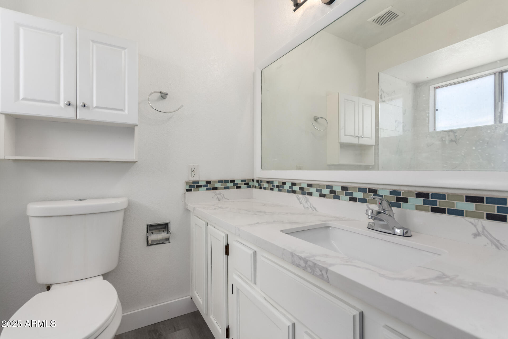 4162 East Wayland Road Phoenix, AZ 85040 - Photo 13 of 36 a bathroom with a sink and a toilet