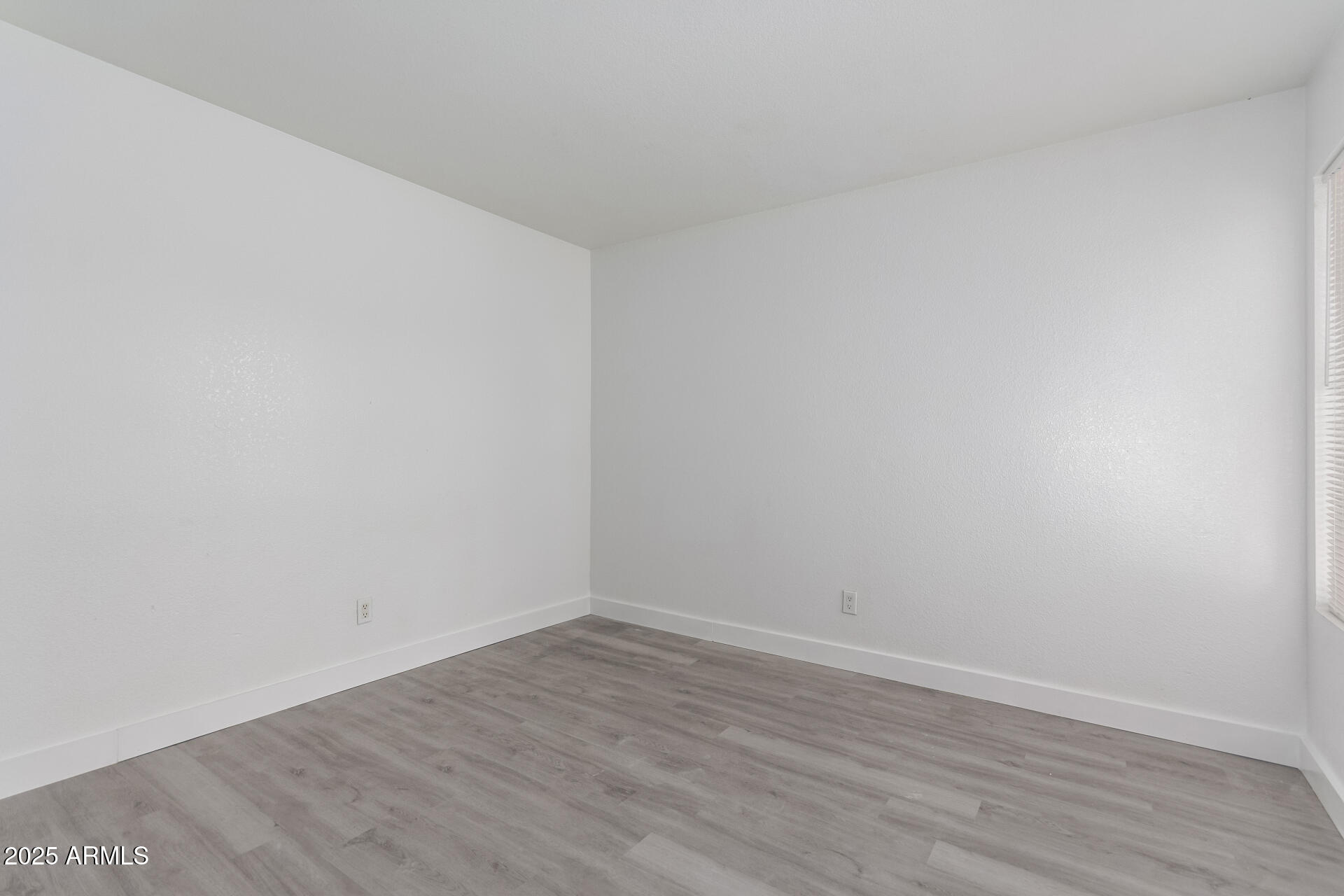 4162 East Wayland Road Phoenix, AZ 85040 - Photo 15 of 36 a view of an empty room with wooden floor
