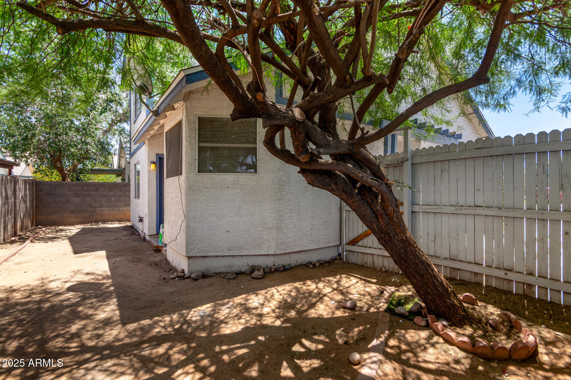 4162 East Wayland Road Phoenix, AZ 85040 - Photo 23 of 36 a house with trees in front of it