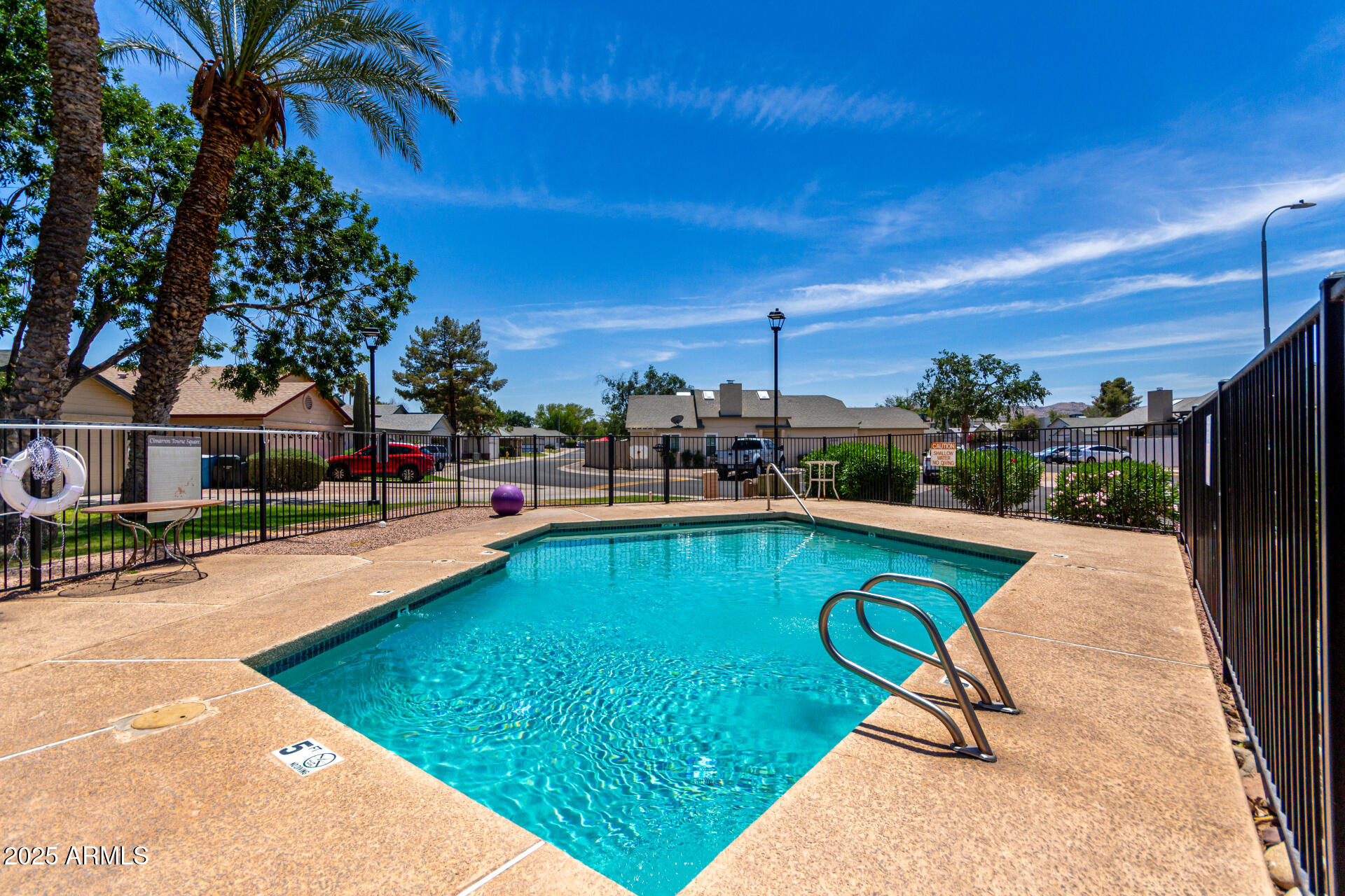 4162 East Wayland Road Phoenix, AZ 85040 - Photo 28 of 36 a view of swimming pool that has lawn chairs with plants and palm trees