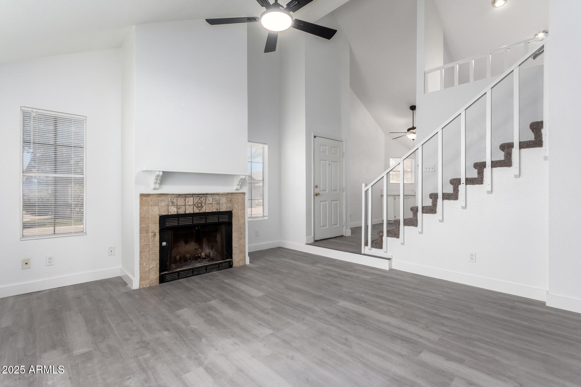 4162 East Wayland Road Phoenix, AZ 85040 - Photo 3 of 36 a view of an empty room with wooden floor fireplace and a window