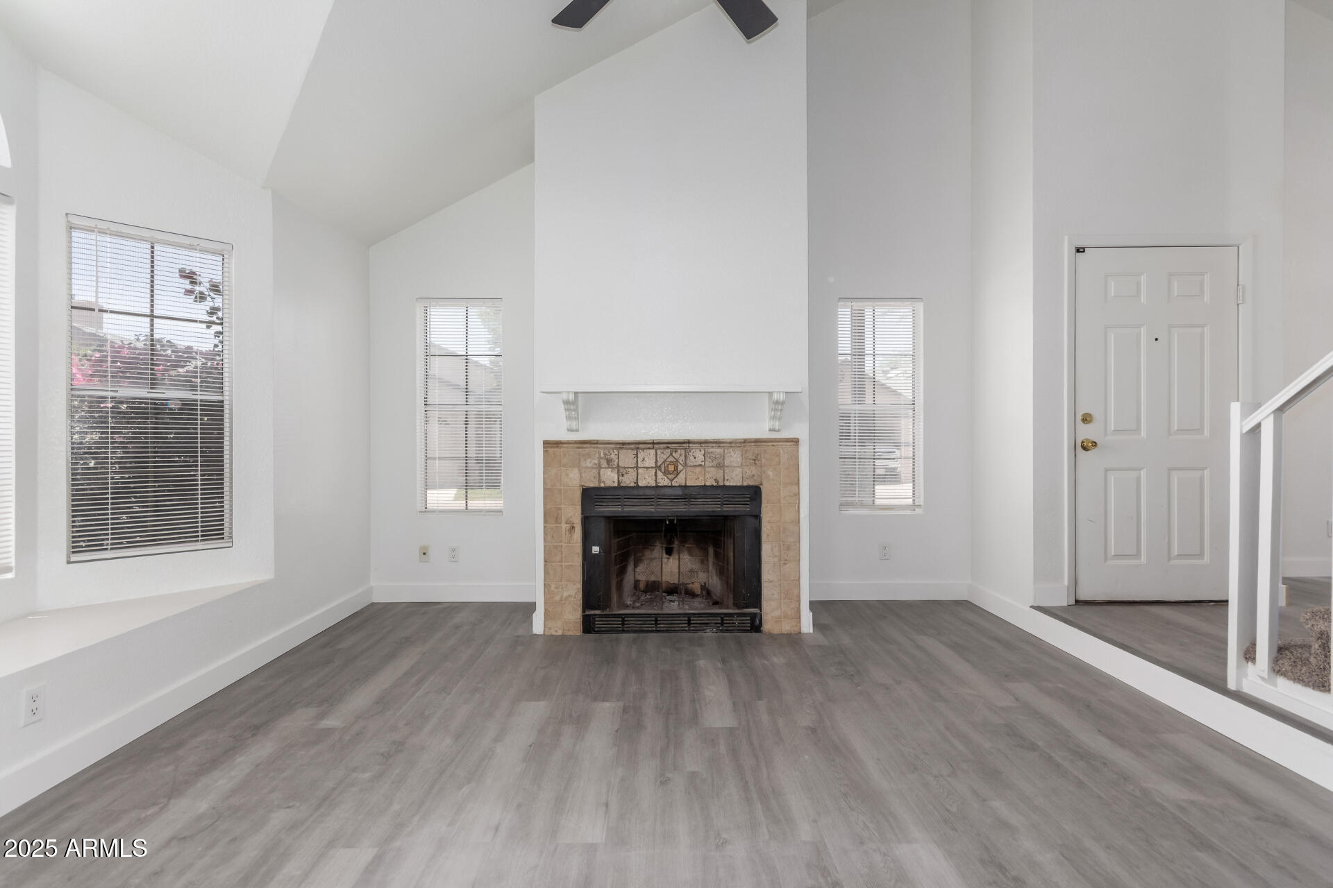 4162 East Wayland Road Phoenix, AZ 85040 - Photo 5 of 36 a view of an empty room with wooden floor and a window