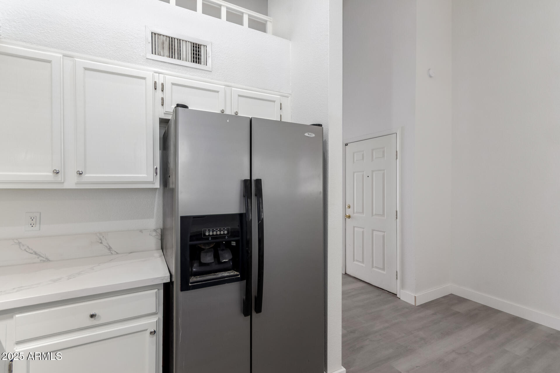 4162 East Wayland Road Phoenix, AZ 85040 - Photo 8 of 36 a kitchen with stainless steel appliances a refrigerator and cabinets